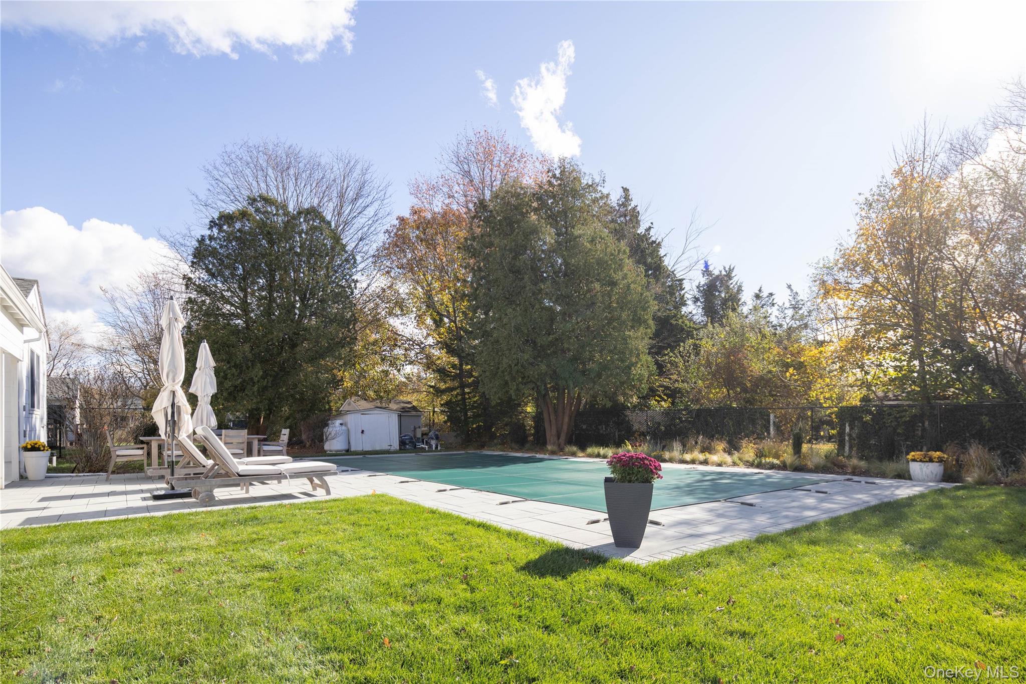 920 Pine Neck Road Southold, NY 11971 - Photo 18 of 28 a view of a fire pit with large trees