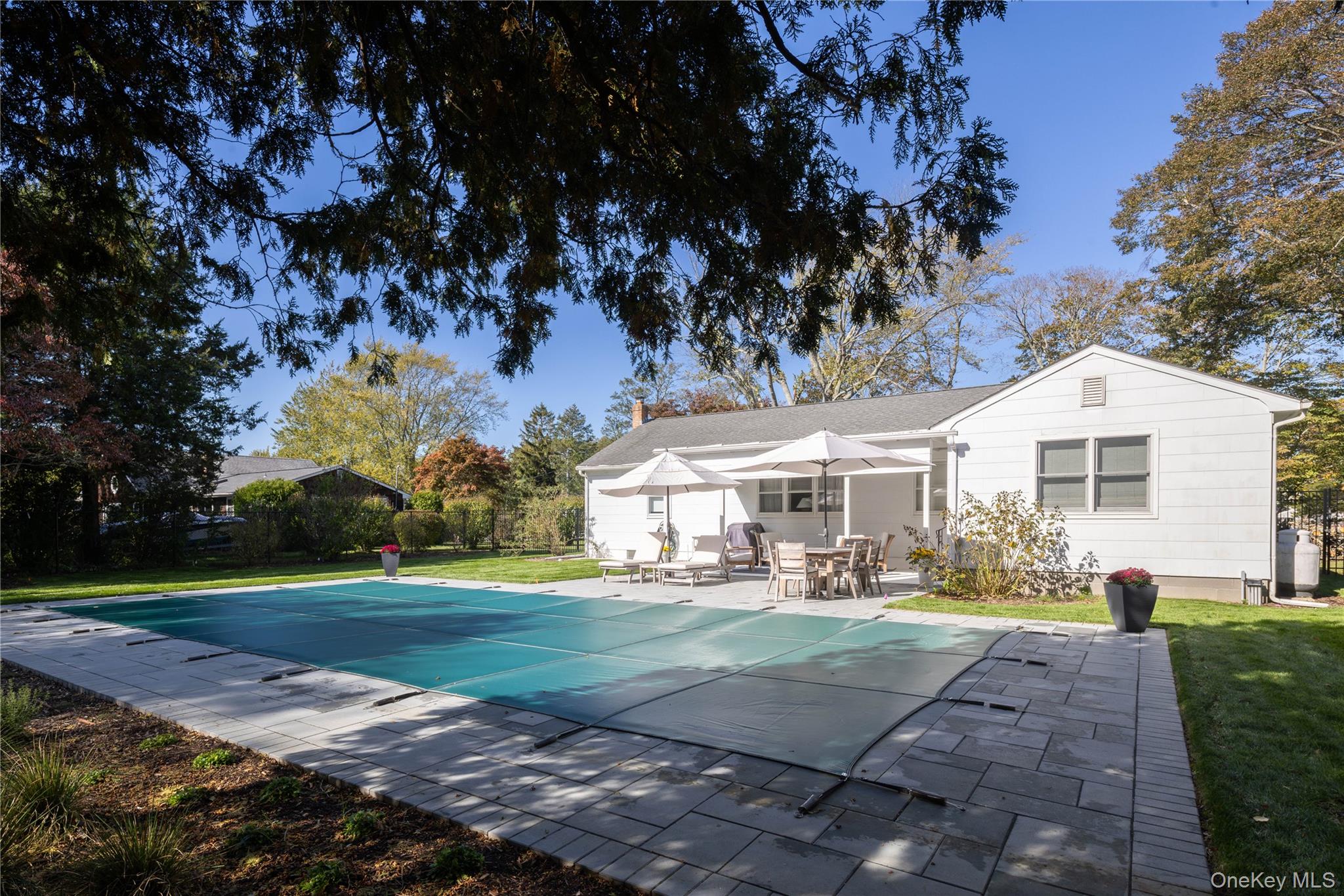 920 Pine Neck Road Southold, NY 11971 - Photo 21 of 28 a front view of a house with a yard and trees