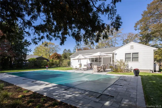 a front view of a house with a yard and trees