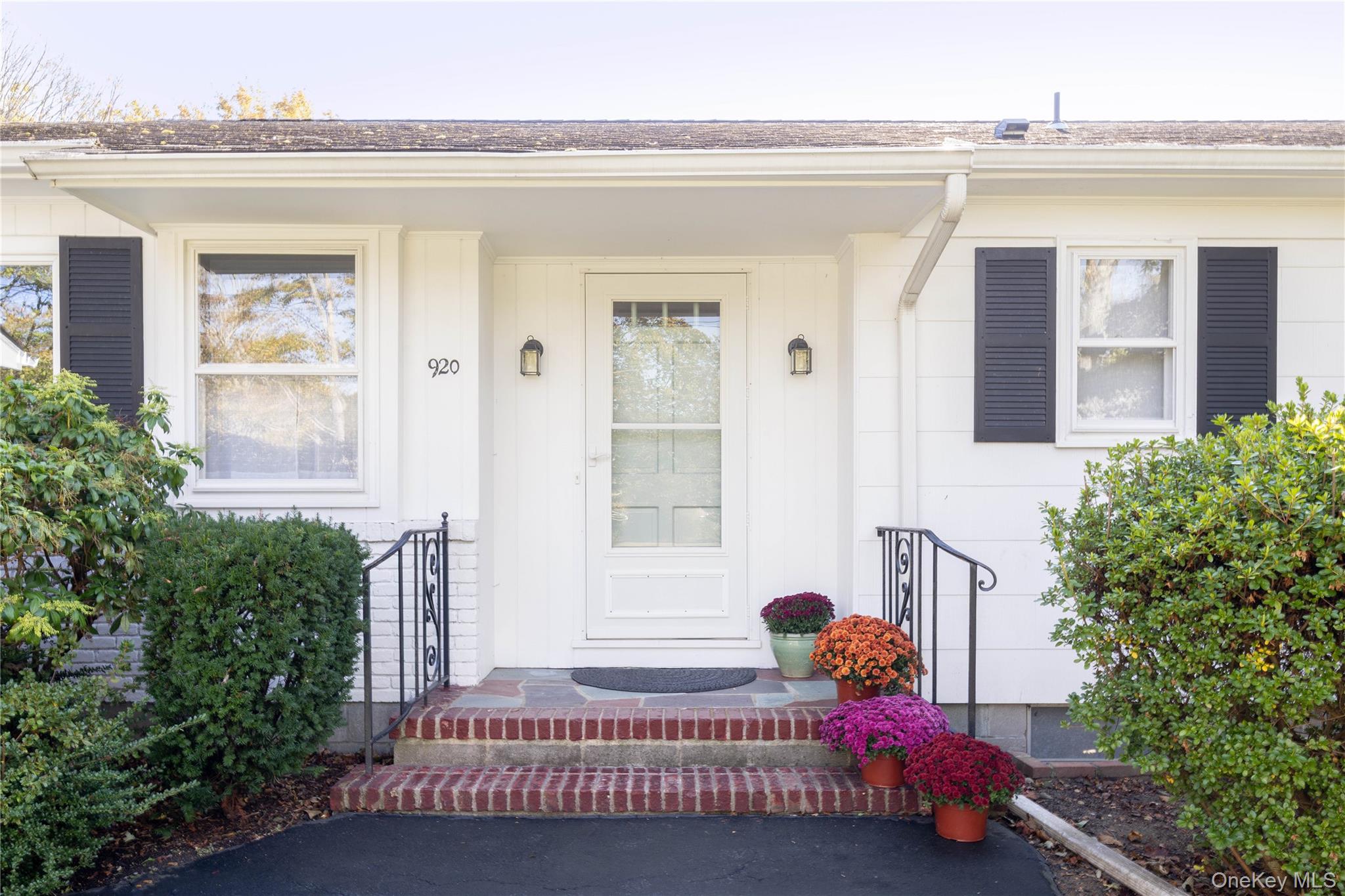920 Pine Neck Road Southold, NY 11971 - Photo 24 of 28 a bedroom with a bed and windows