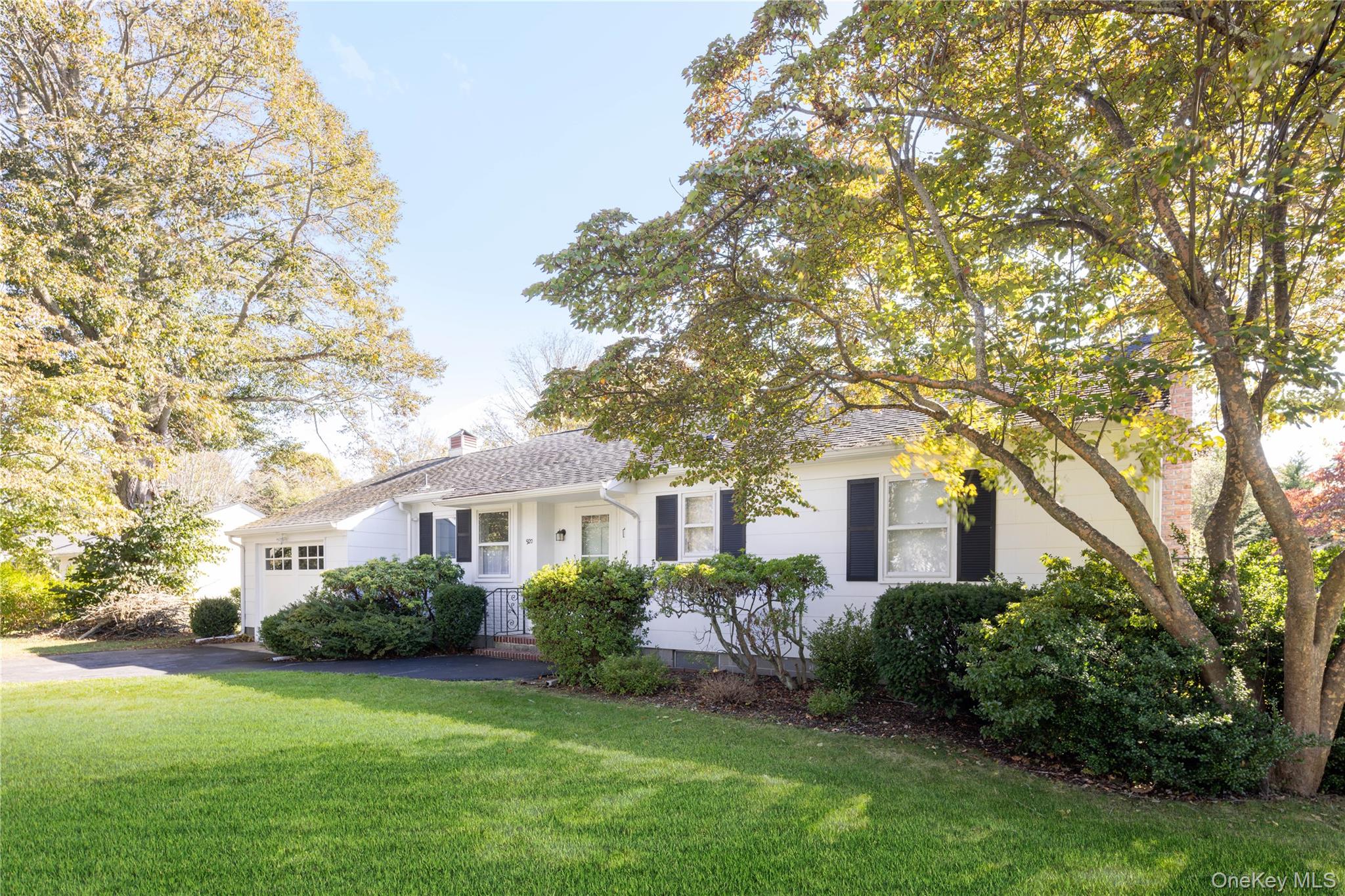 920 Pine Neck Road Southold, NY 11971 - Photo 25 of 28 a front view of a house with a garden