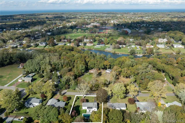 an aerial view of residential building and lake