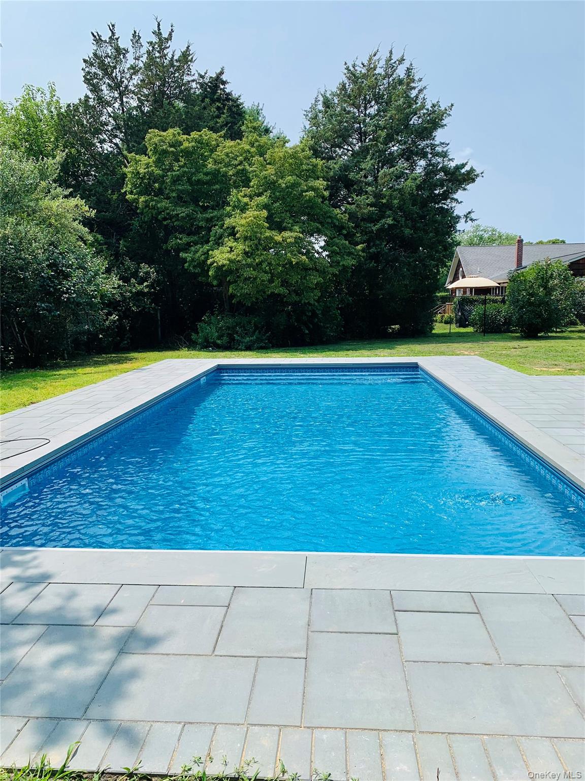 920 Pine Neck Road Southold, NY 11971 - Photo 3 of 28 a view of swimming pool with lounge chair