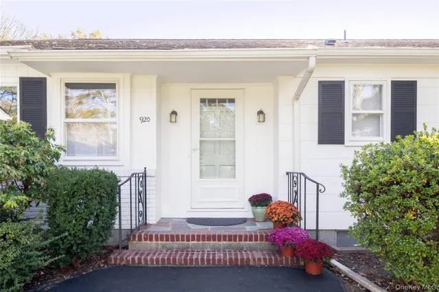 a bedroom with a bed and windows