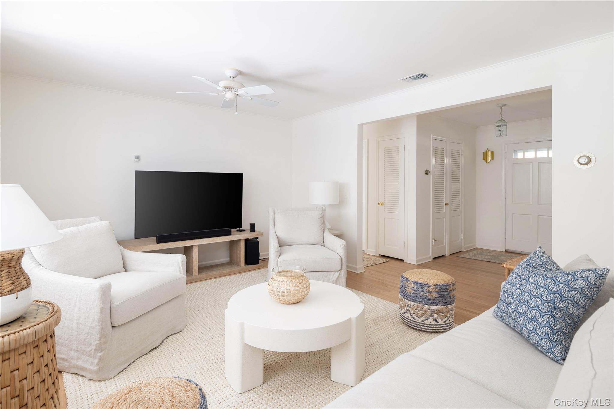 920 Pine Neck Road Southold, NY 11971 - Photo 5 of 28 a living room with furniture and a flat screen tv