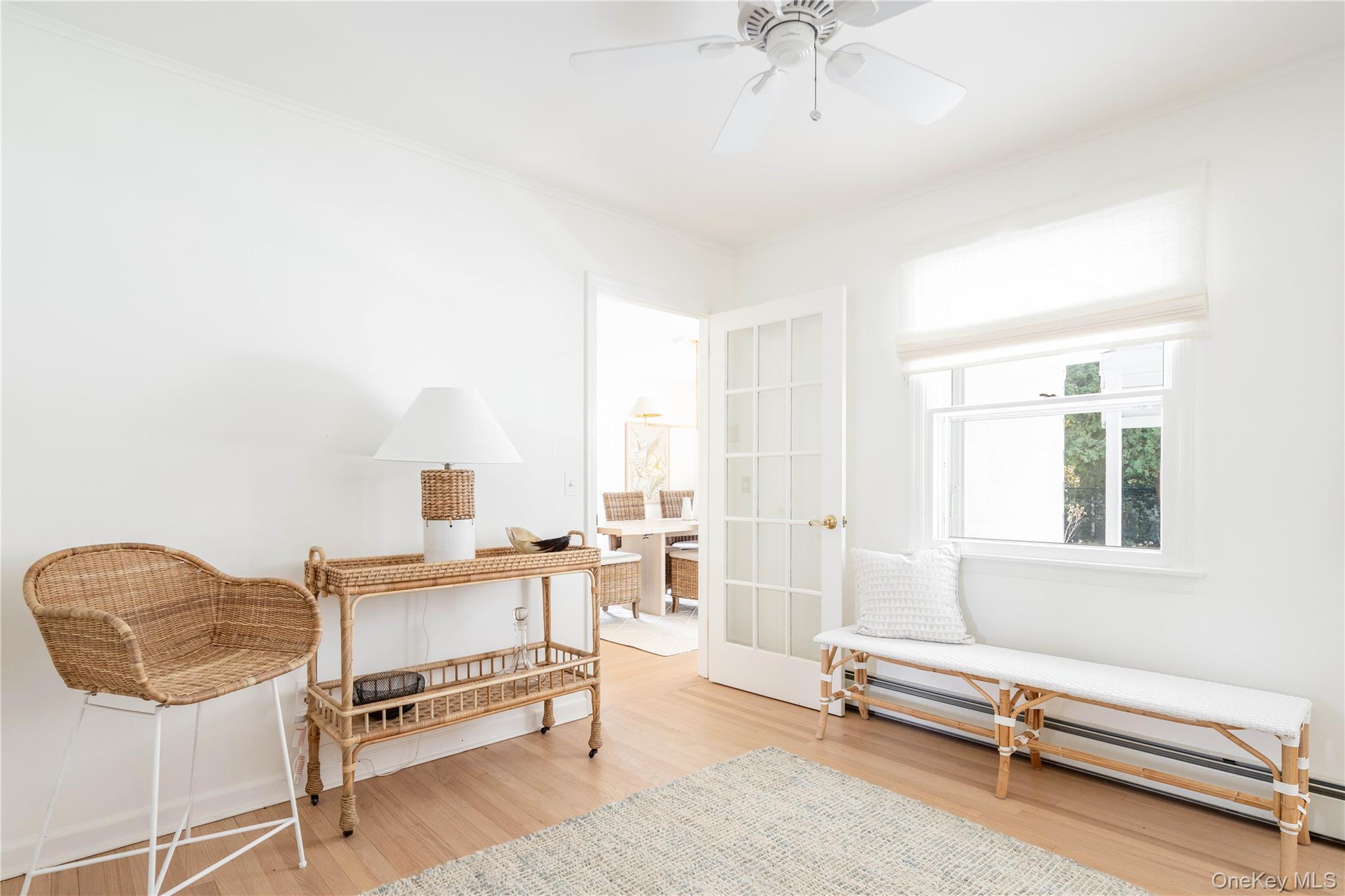 920 Pine Neck Road Southold, NY 11971 - Photo 8 of 28 a living room with furniture a ceiling fan and a rug