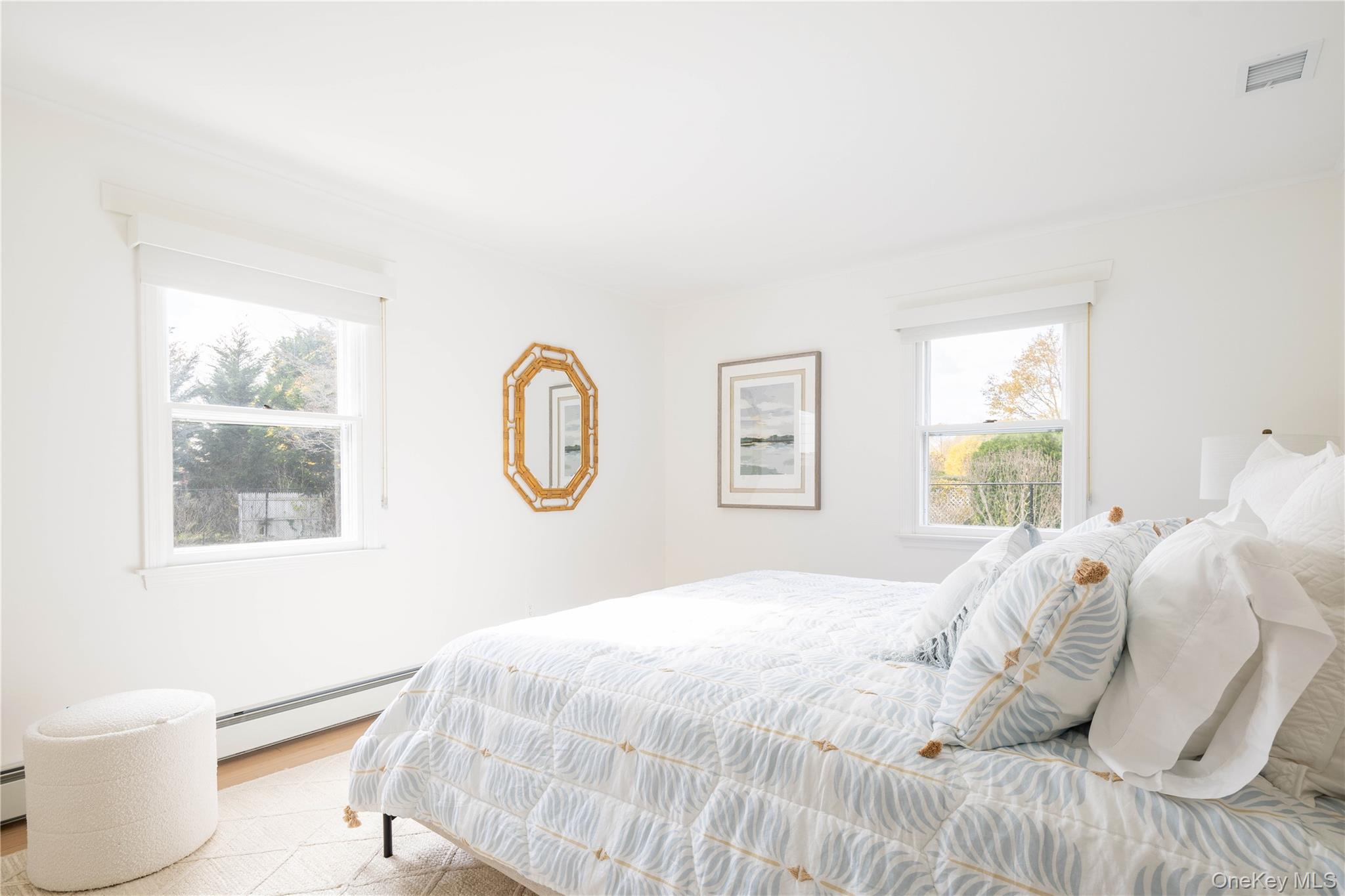 920 Pine Neck Road Southold, NY 11971 - Photo 9 of 28 a bedroom with a bed and a window