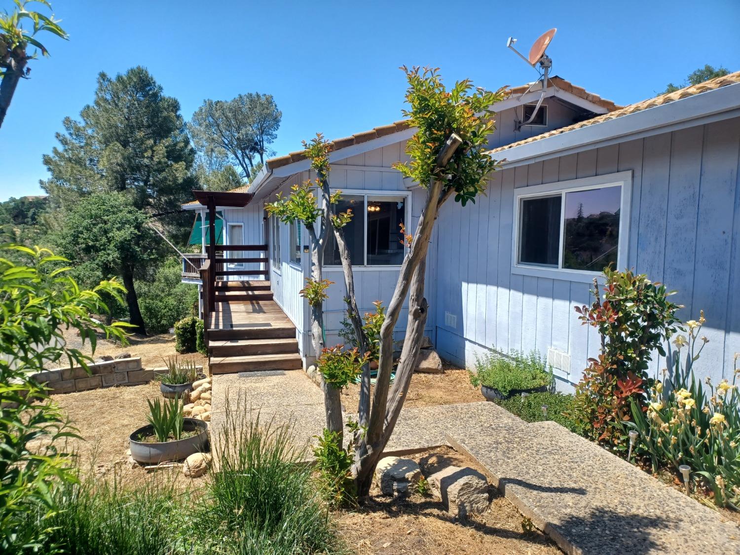 97 Poker Flat Road Copperopolis, CA 95228 - Photo 1 of 1 a view of a house with backyard and sitting area