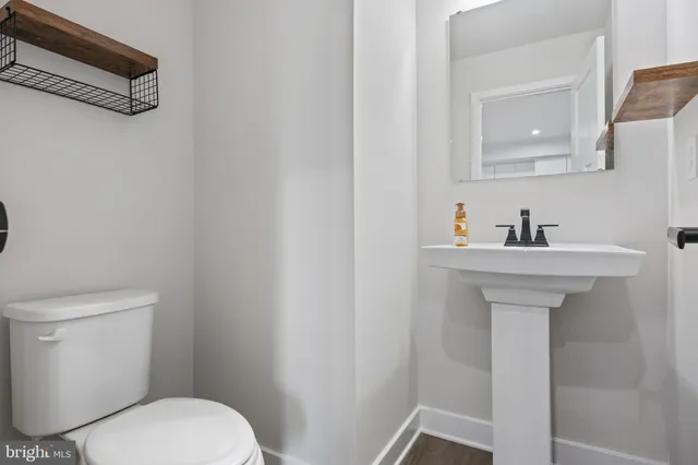 a bathroom with a sink a mirror and a toilet