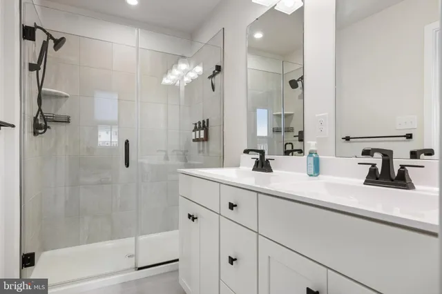 a bathroom with a shower sink and mirror