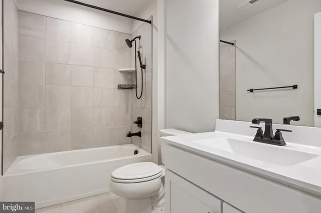 a bathroom with a sink a toilet and a bathtub