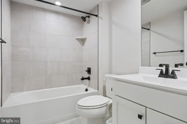 a bathroom with a sink a toilet and a bathtub