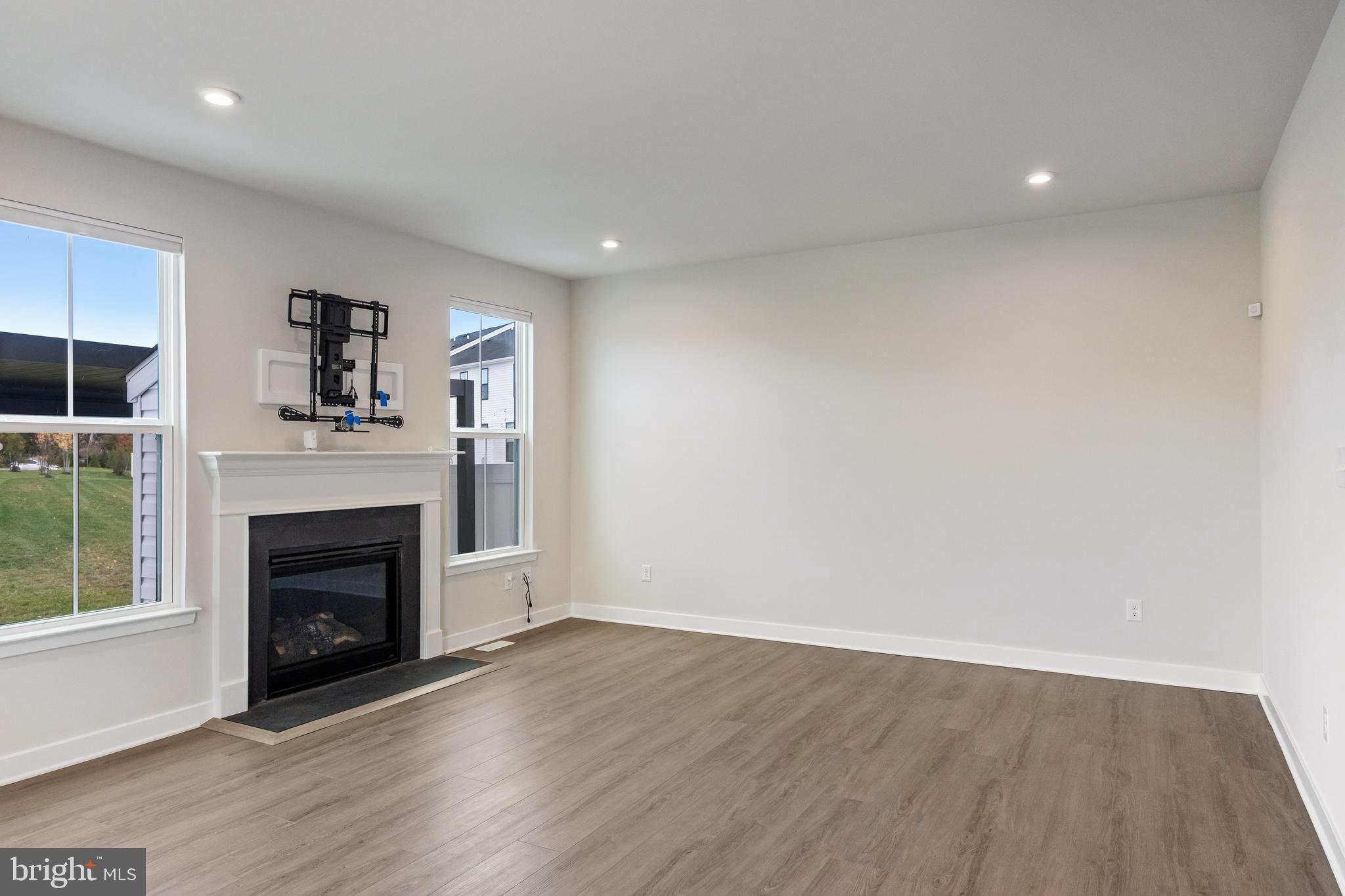 2 Rosemary Way Mount Laurel, NJ 08054 - Photo 10 of 28 an empty room with wooden floor and fireplace