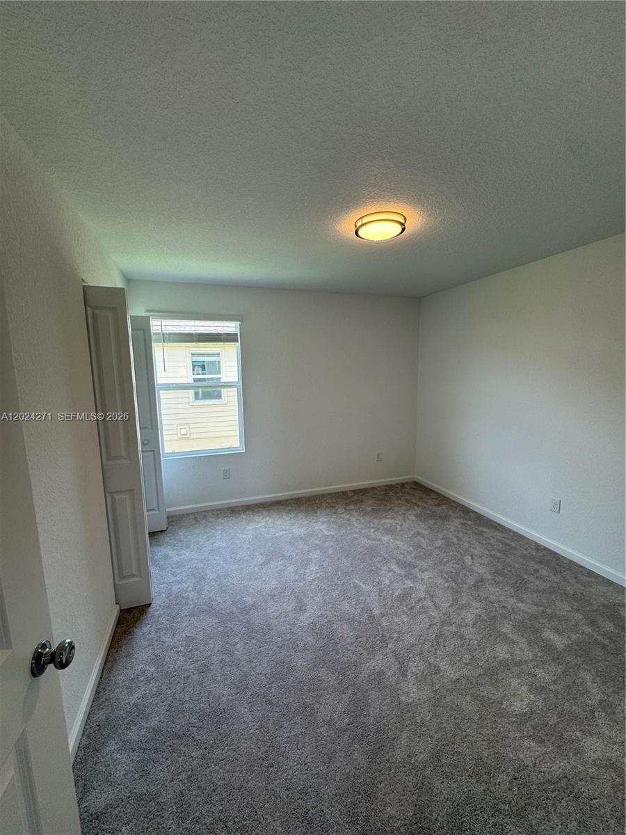 693 Carlyle Way Fort Pierce, FL 34947 - Photo 14 of 19 an empty room with a window