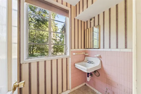 a bathroom with a sink a mirror and a window