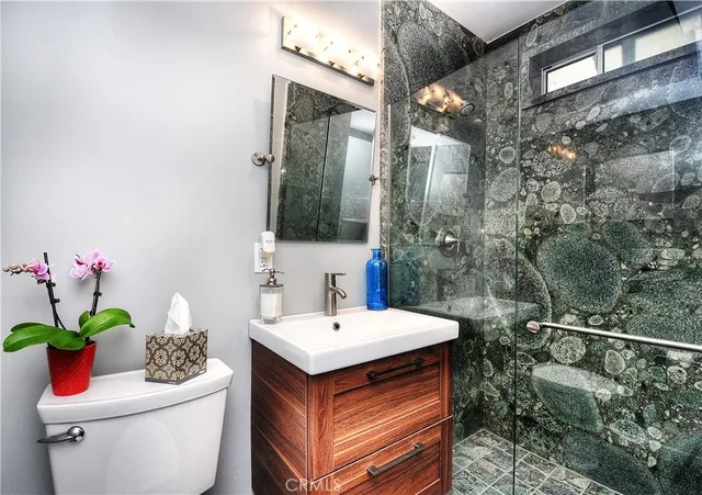 a bathroom with a sink mirror and toilet