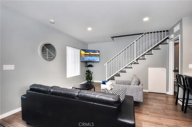 a living room with furniture and a floor to ceiling window