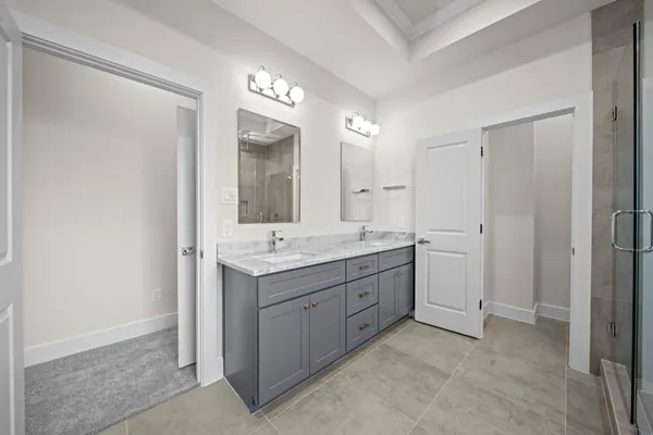a bathroom with a double vanity sink and mirror
