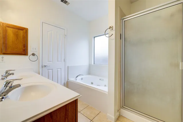 a bathroom with a tub sink and mirror