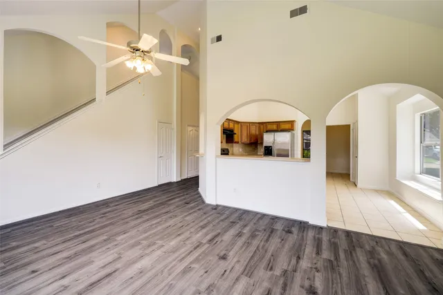 a view of a living room and bathroom with wooden floor