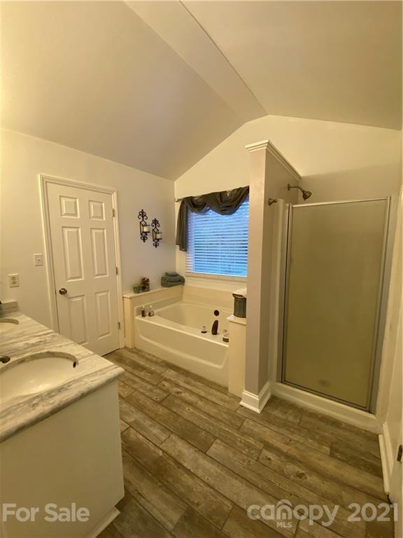 6865 Gold Hill Road Concord, NC 28025 - Photo 14 of 36 a bathroom with a tub sink and mirror