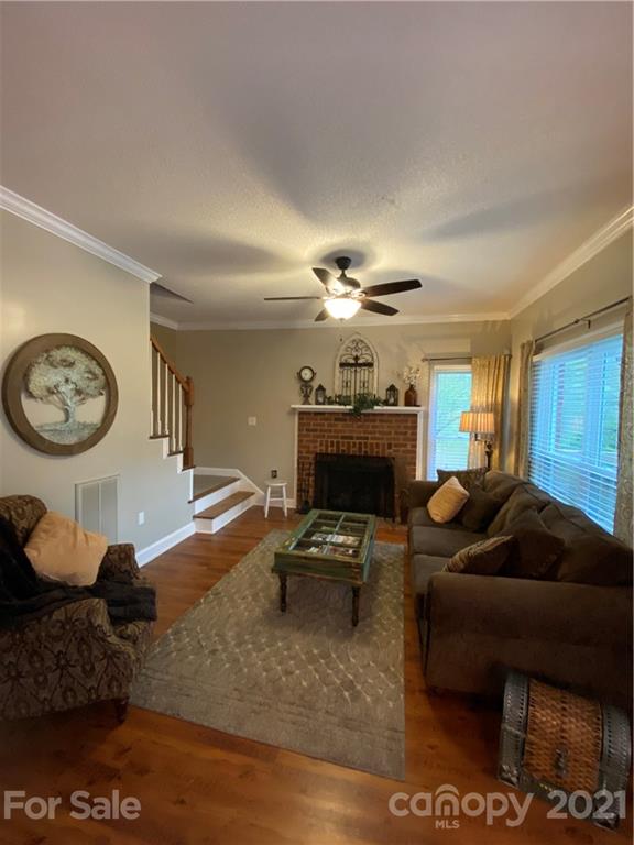 6865 Gold Hill Road Concord, NC 28025 - Photo 22 of 36 a living room with furniture a clock and a fireplace