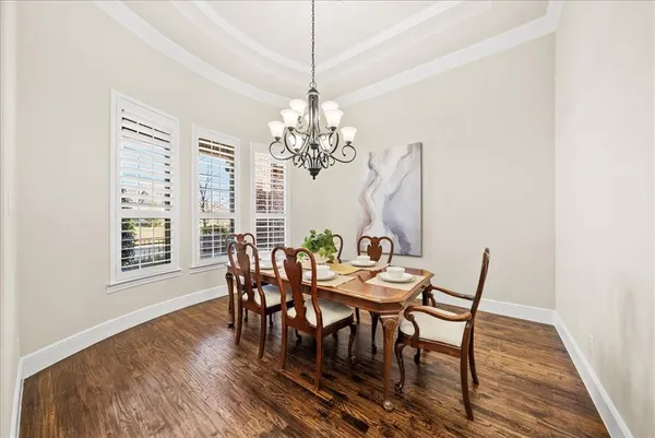 a spacious bedroom with a bed a large mirror and furniture