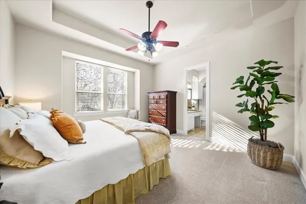 a bathroom with a granite countertop sink a toilet a mirror and bathtub