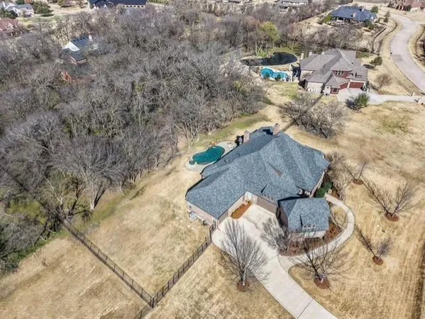 an aerial view of a house with garden space and street view