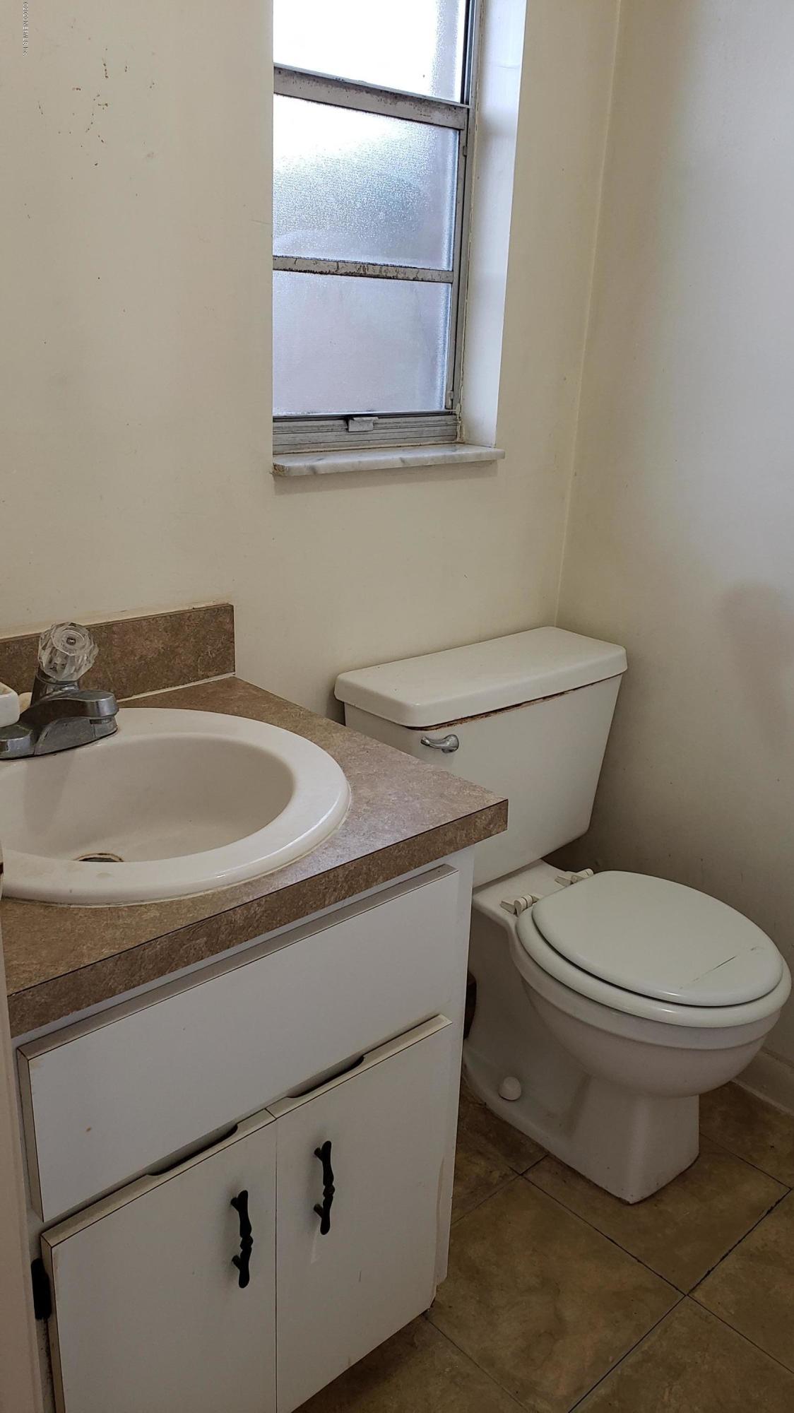 7208 Parker School Road, Unit 7 Jacksonville, FL 32211 - Photo 14 of 15 a bathroom with a toilet and a sink