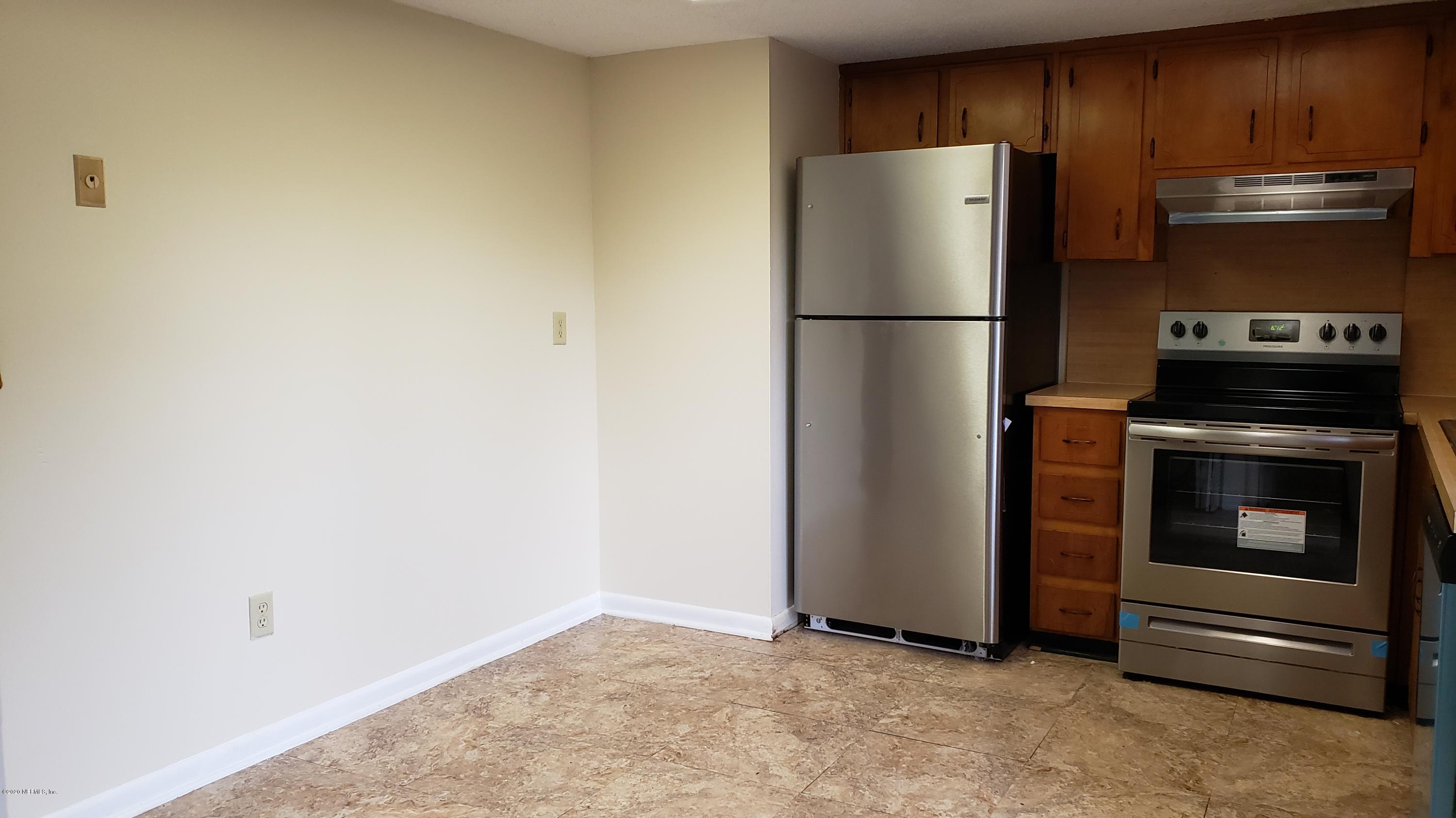 7208 Parker School Road, Unit 7 Jacksonville, FL 32211 - Photo 2 of 15 a kitchen with a refrigerator and a stove