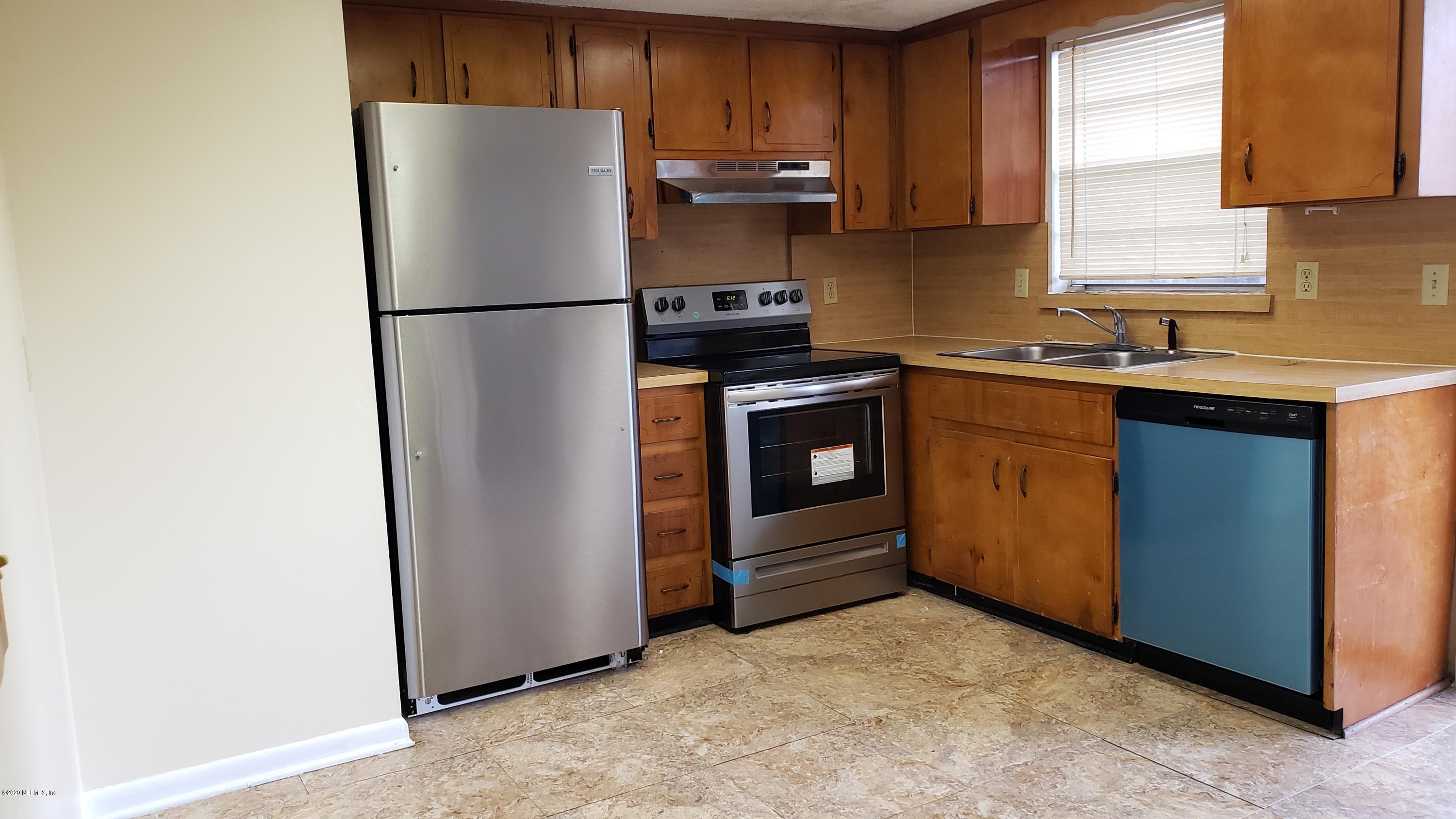7208 Parker School Road, Unit 7 Jacksonville, FL 32211 - Photo 3 of 15 a kitchen with a refrigerator sink and stove