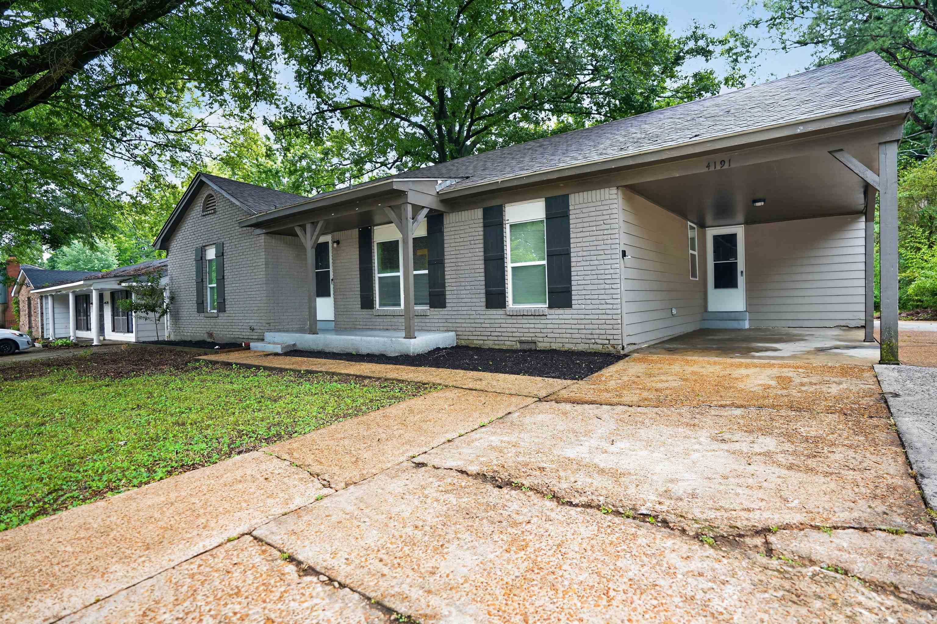 4191 Yale Road Memphis, TN 38128 - Photo 3 of 22 Gray brick exterior with a covered front porch featuring white columns