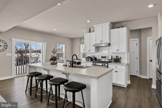 a kitchen with appliances a sink and cabinets