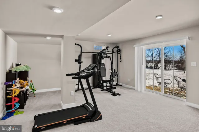 a room with gym equipment and a large window