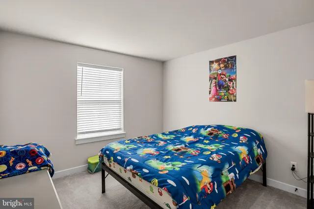 a bedroom with two beds and a window