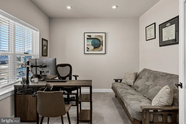 a living room with furniture a flat screen tv and a window