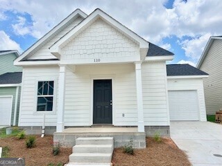 a front view of a house with garage