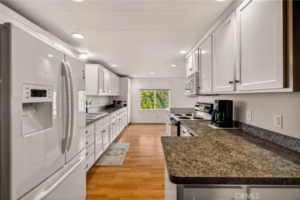 a living room with furniture a fireplace and large windows