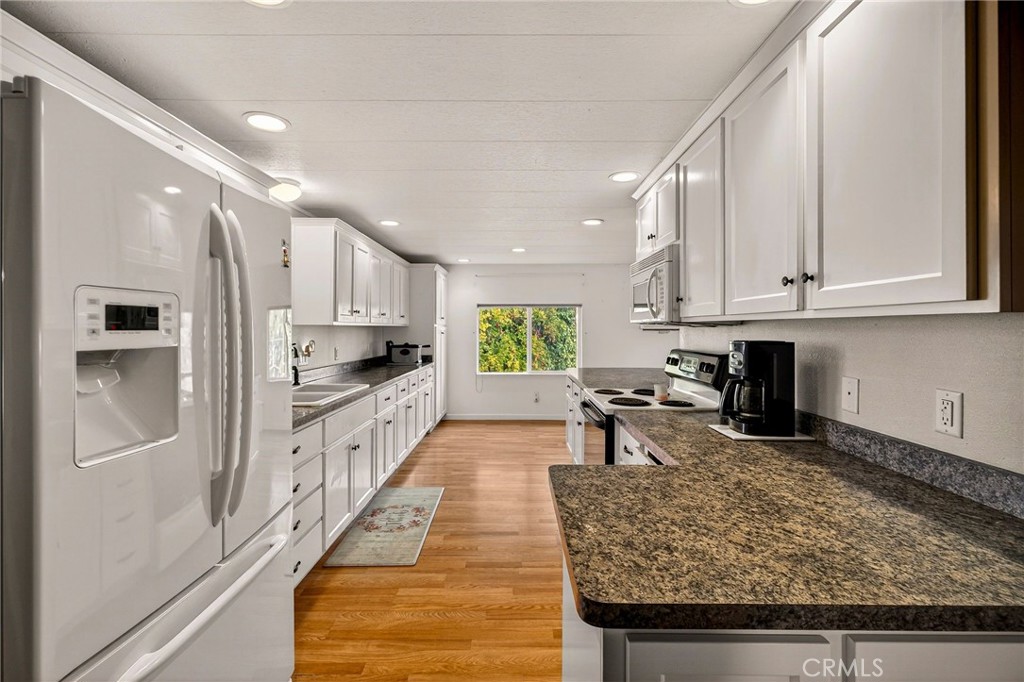 4783 County Orland, CA 95963 - Photo 12 of 73 a kitchen with stainless steel appliances granite countertop a refrigerator sink and cabinets