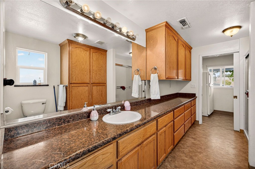 4783 County Orland, CA 95963 - Photo 39 of 73 a bathroom with a granite countertop sink and a mirror