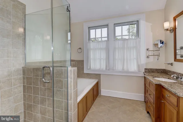 a bathroom with a tub shower and sink