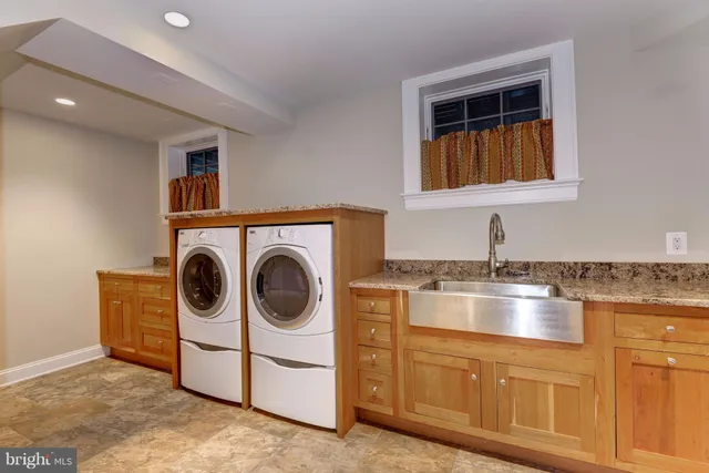 a utility room with sink dryer and washer