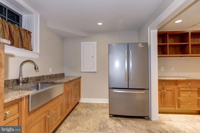 a kitchen with stainless steel appliances granite countertop a refrigerator and a sink