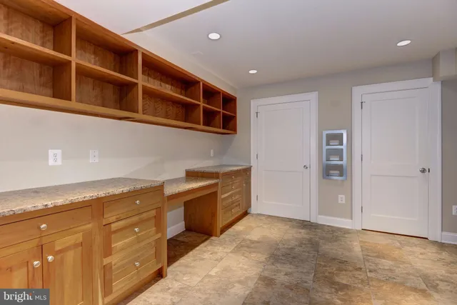 a large kitchen with stainless steel appliances granite countertop a refrigerator and a sink