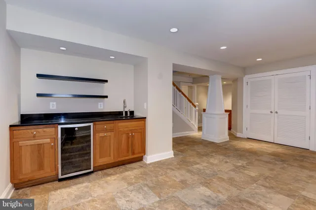 an empty room with closet and mirrors