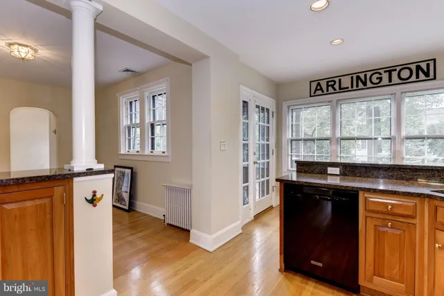 a kitchen with granite countertop a stove and a wooden floor