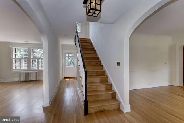 a view of entryway and hall with wooden floor