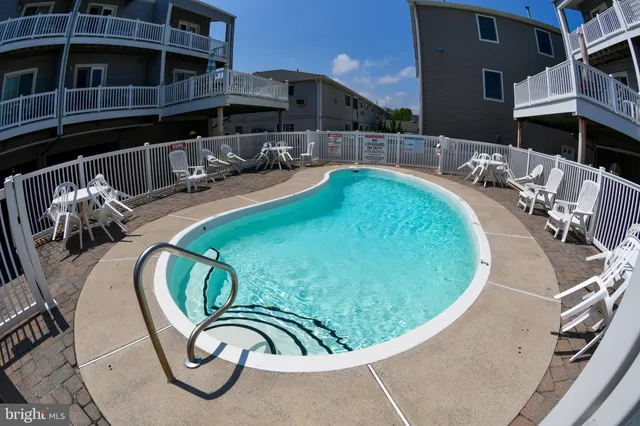 a view of a swimming pool with outdoor seating