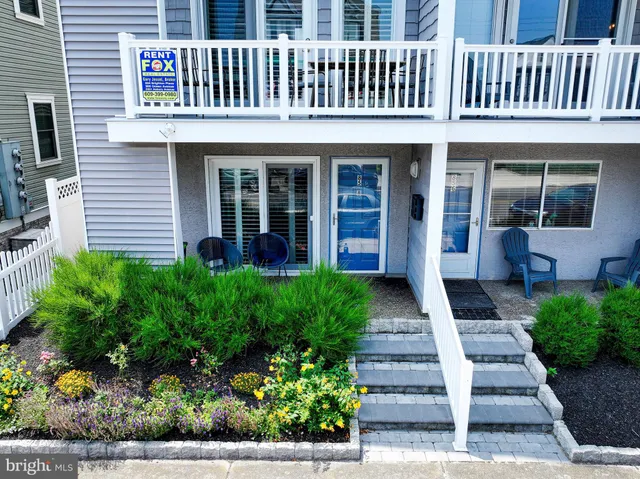 a front view of a house with a yard and plants